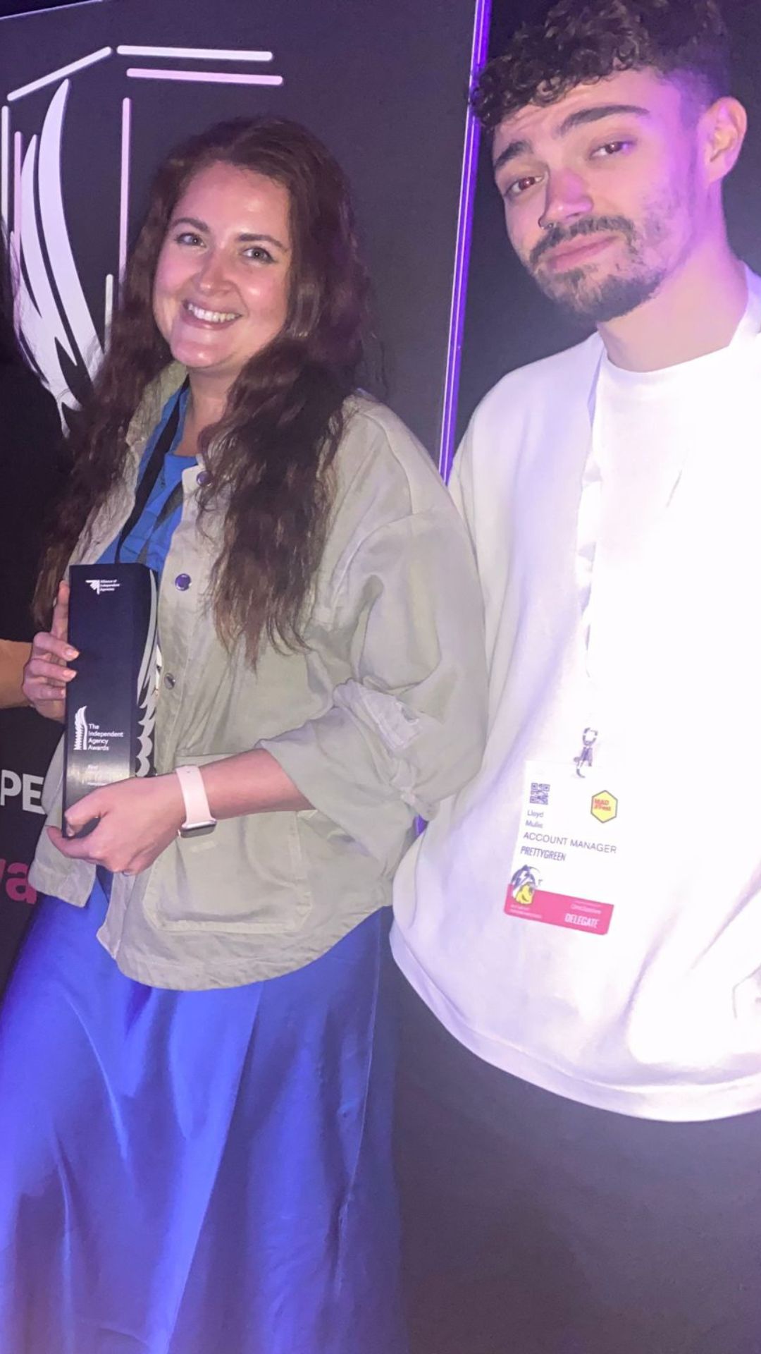 Two of the team holding the award